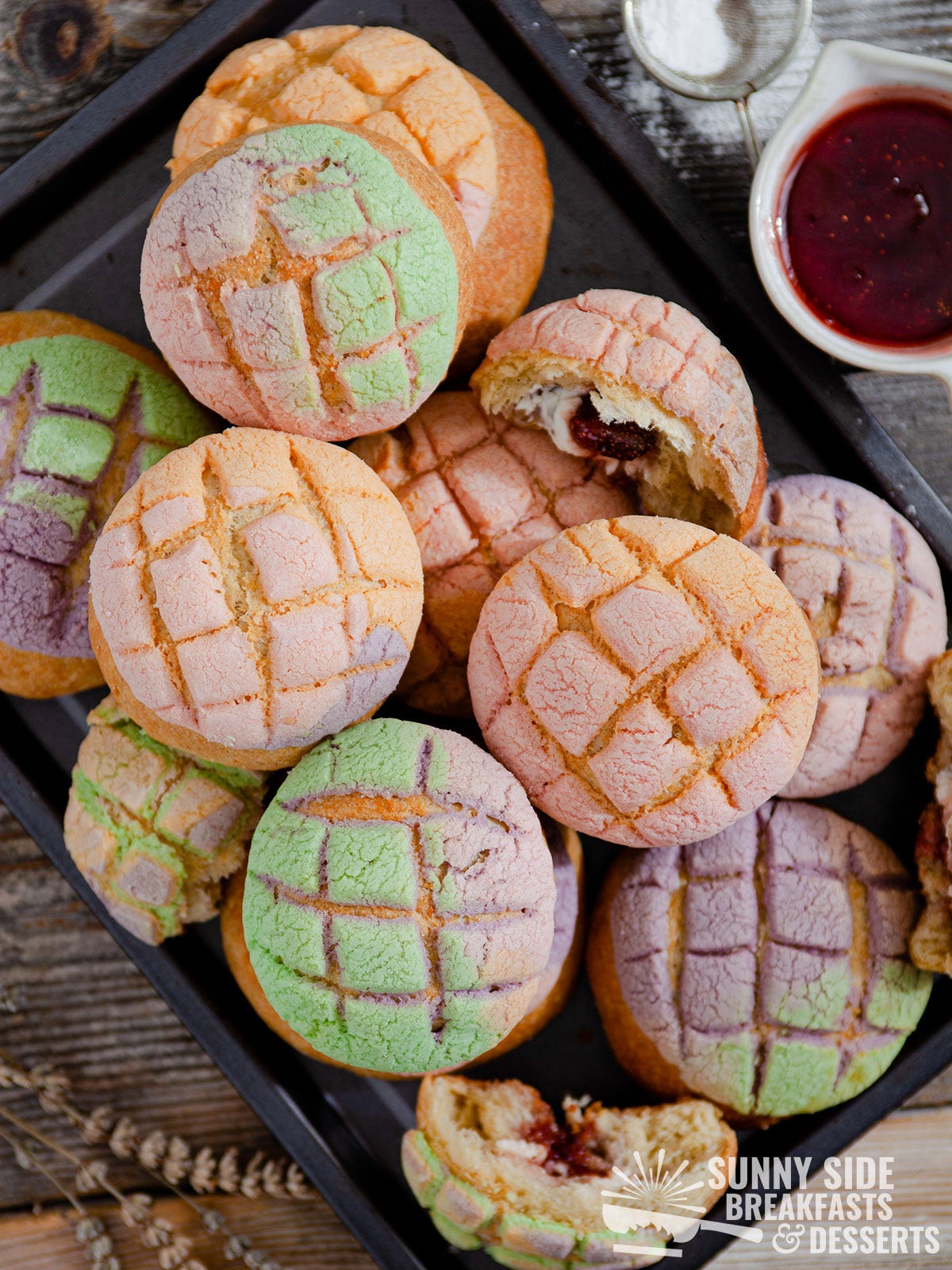 Rainbow conchas on a baking sheet.