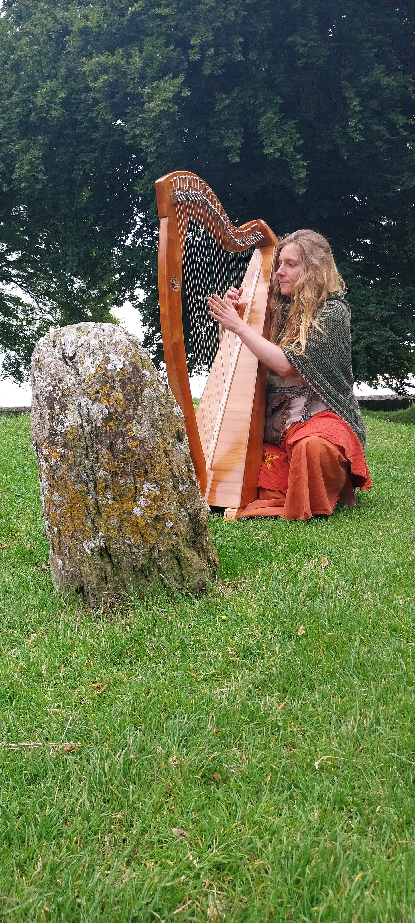 Aoife playing her harp at the hill of tara