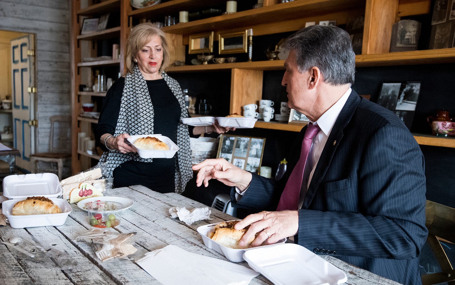 Karen Shannon, owner of the Pepperoni Chic pop up restaurant, serves pepperoni rolls to Sen. Joe Manchin, D-W. Va., on Wednesday, April 11, 2018. (Bill Clark/CQ Roll Call)