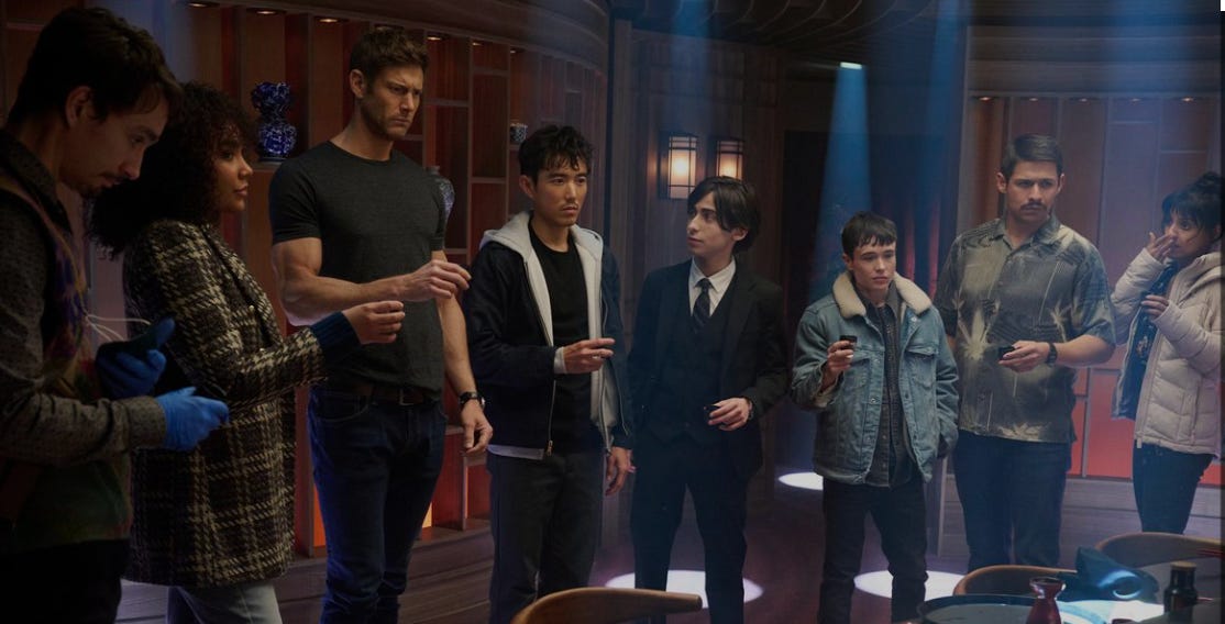 The Umbrella Academy raising their cups in a toast, not looking very excited