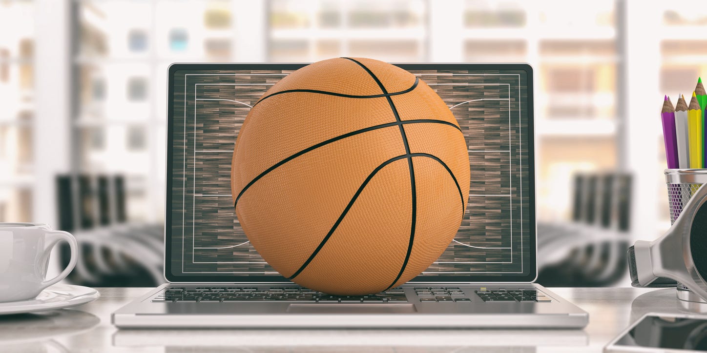 basketball on top of laptop at work desk