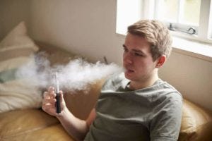Vaping man on couch