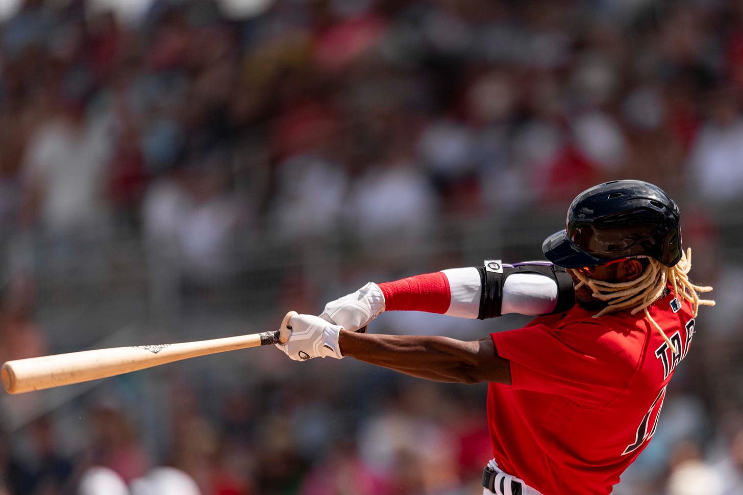 Raimel Tapia makes contact on a swing during Saturday's game against the Astros.