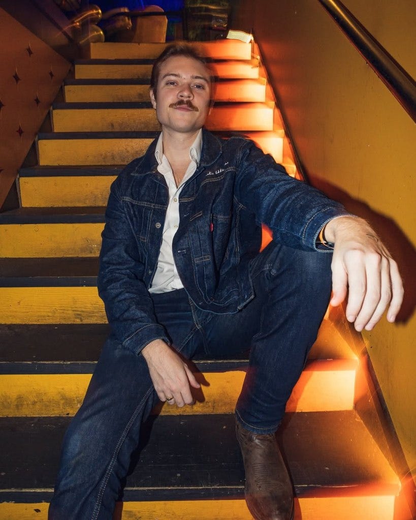 A man sitting on stairs, potentially facing fine for bringing common item from overseas