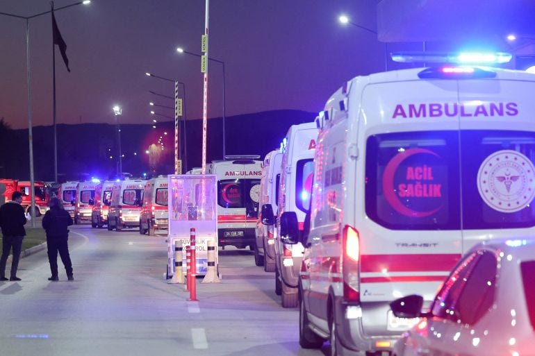 Ambulances line up at the entrance of the headquarters of Turkey's aviation company TUSAS