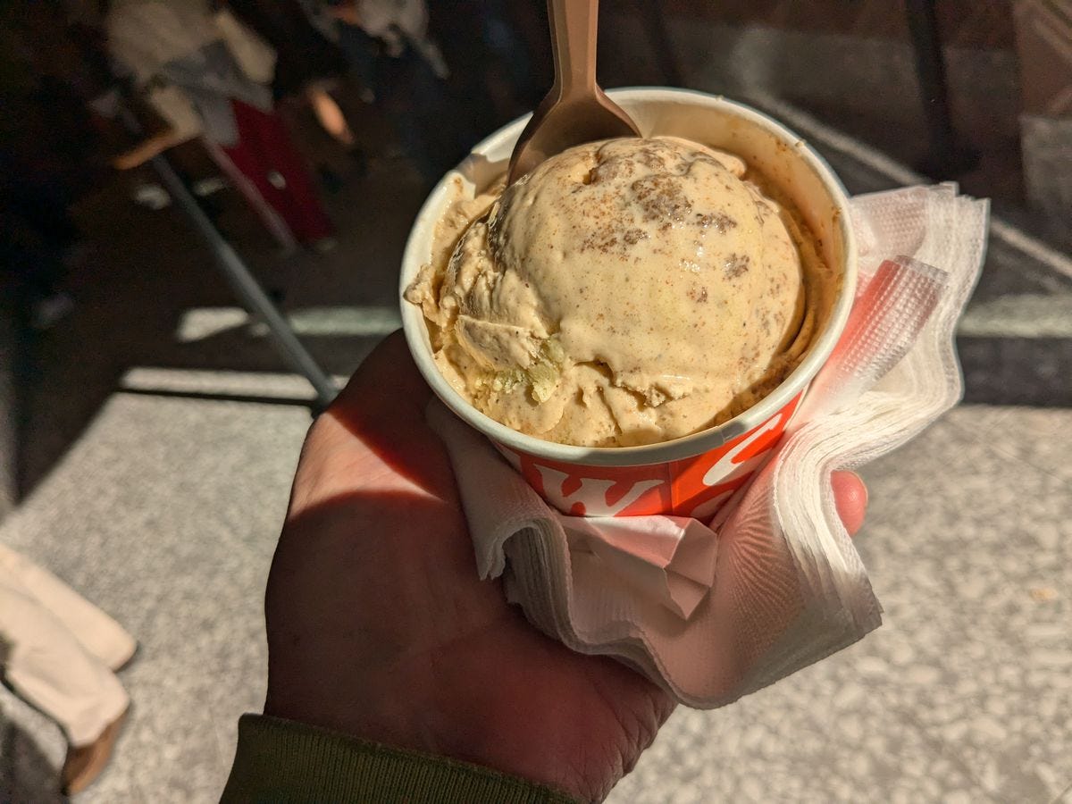 A ball of crumbly yellowish ice cream tightly held in a cup.