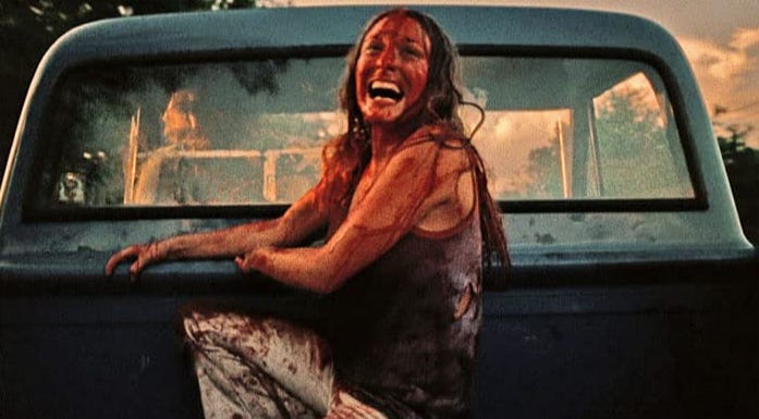 Marilyn Burns covered in blood in the back of a pickup at the end of The Texas Chain Saw Massacre (1974)