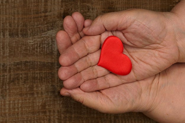 Premium Photo | Top view of the chubby hands of an elderly woman folded on  top of each other in which the heart lies