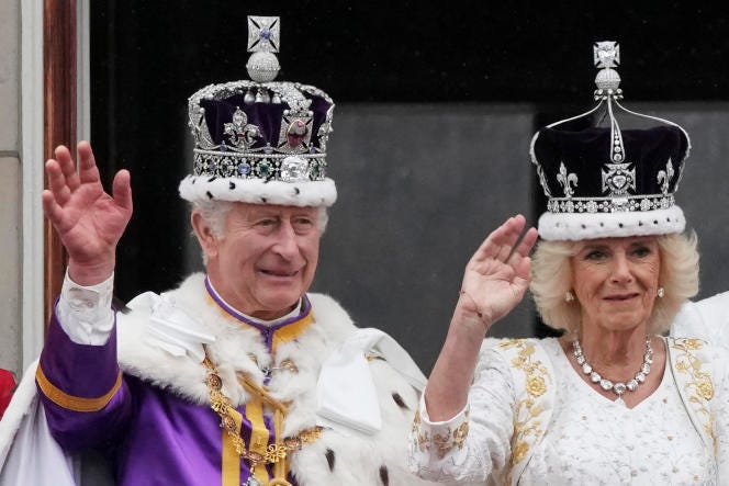 Britain's King Charles III and Queen Camilla wave to the crowds from the balcony of Buckingham Palace after the coronation ceremony in London, Saturday, May 6, 2023. 