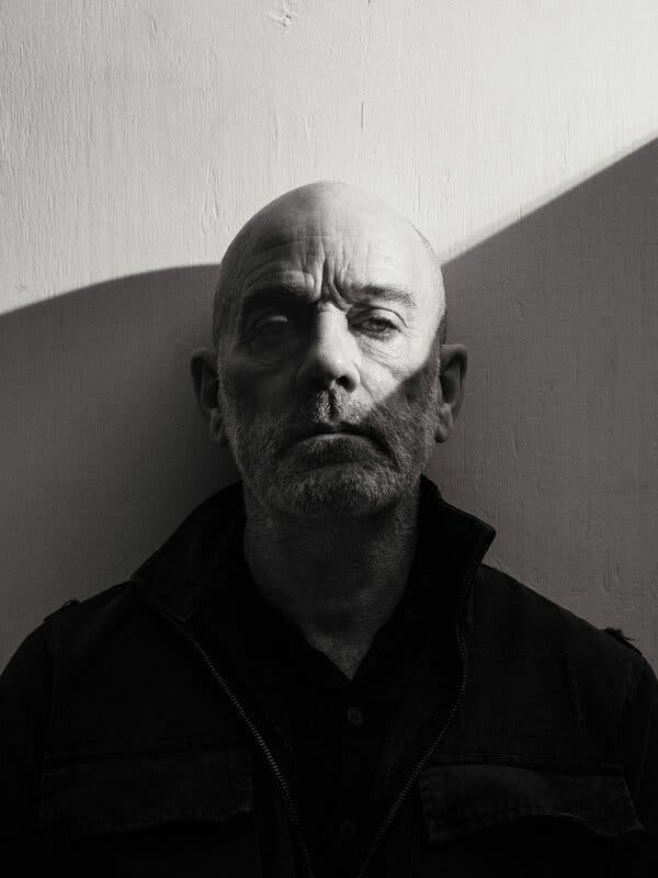 A black-and-white portrait of Michael Stipe.
