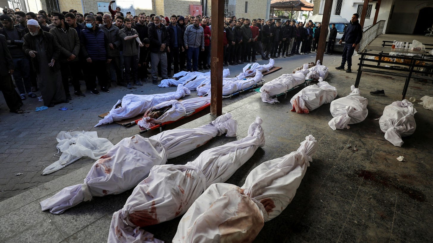 Mourners gather to pray next to the bodies of Palestinian men from an array of tribes and factions, who secure aid convoys in Gaza, after they were killed in an Israeli strike, in Gaza City, 20 March 2024 (Reuters/Dawoud Abu Alkas)