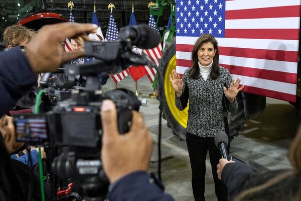 Nikki Haley being filmed while standing in front of a U.S. flag.