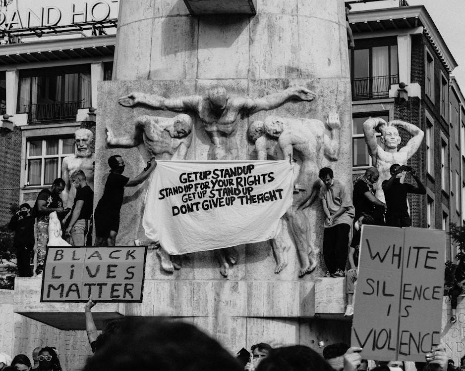 Free Black and white of crowd of people standing on city street with carton boards during social protest Stock Photo