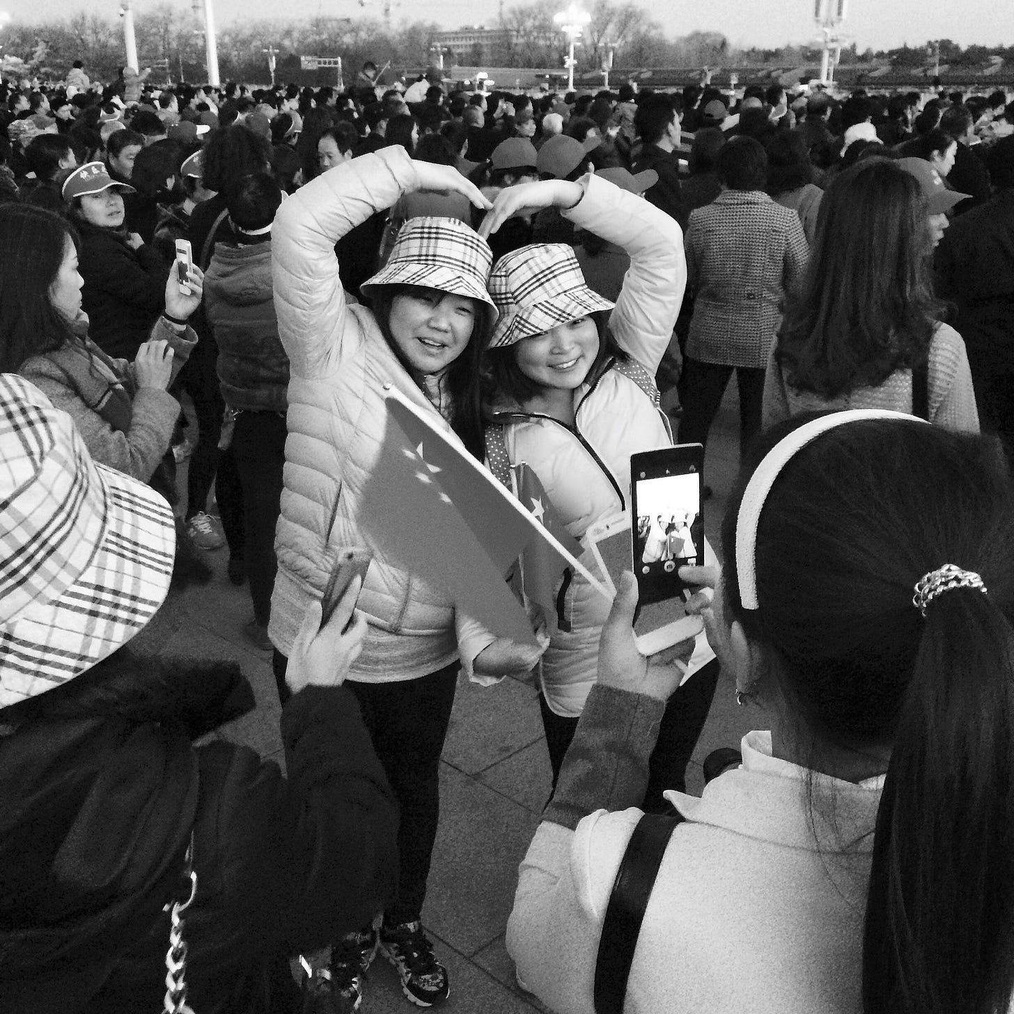 At dawn, thousands gather in Beijing's Tiananmen Square for the flag-raising ceremony.