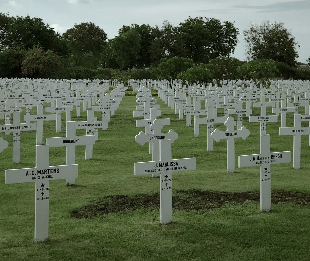 white and green cross on green grass field during daytime white and green cross on green grass field during daytime