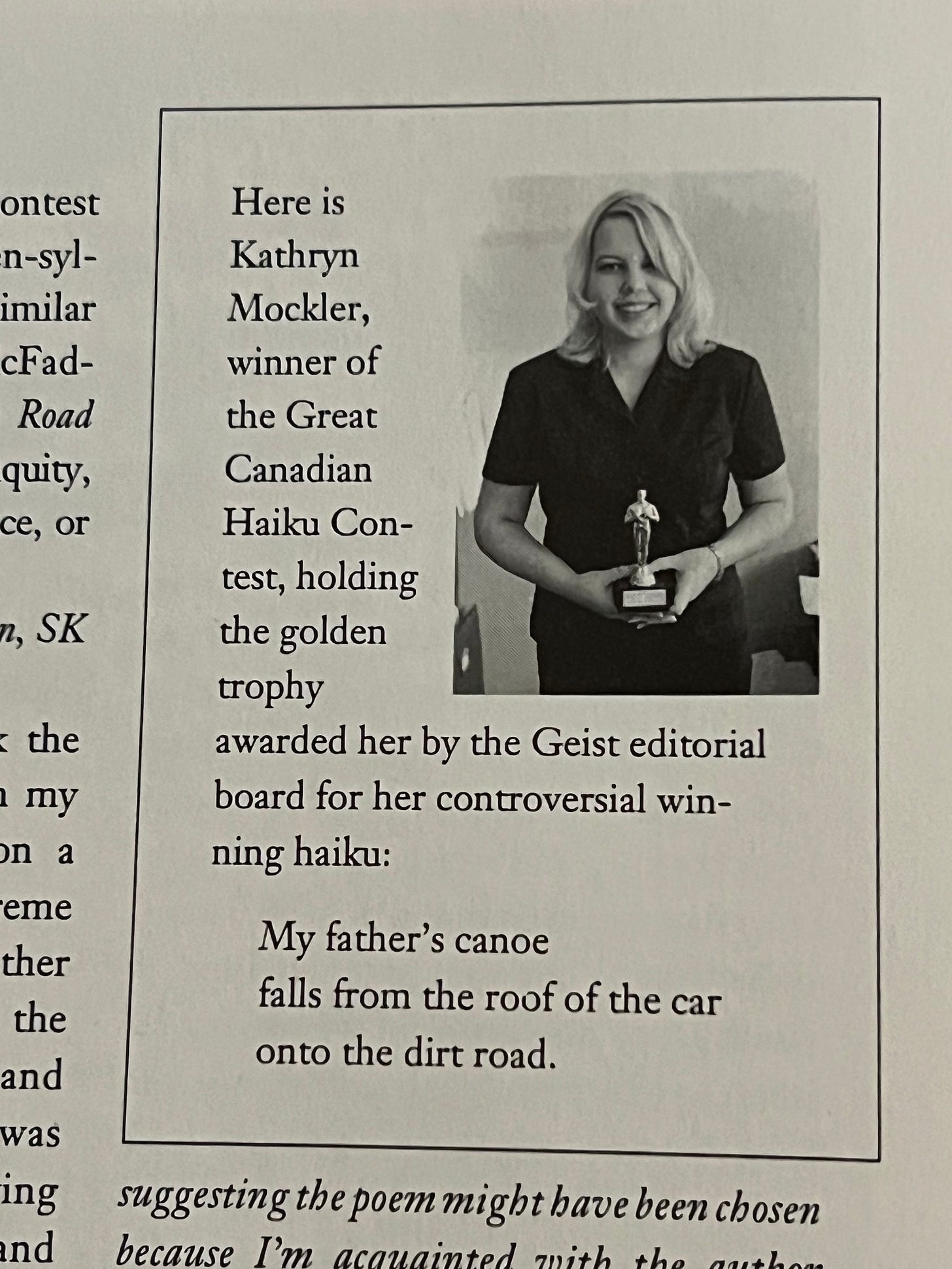 Kathryn Mockler holding her haiku trophy. The haiku reads: My father's canoe / falls from the roof of the car / onto the dirt road.