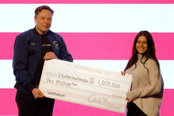 Elon Musk presents a check for $1 million dollars during a town hall Sunday, March 30, 2025, in Green Bay, Wis. (AP Photo/Jeffrey Phelps) Elon Musk presents a check for $1 million dollars during a town hall Sunday, March 30, 2025, in Green Bay, Wis. (AP Photo/Jeffrey Phelps)