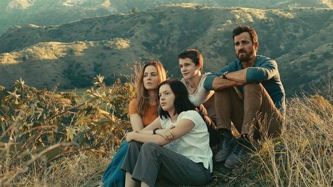 Photo of the Foxes, the family in The Mosquito Coast, sitting on a hill