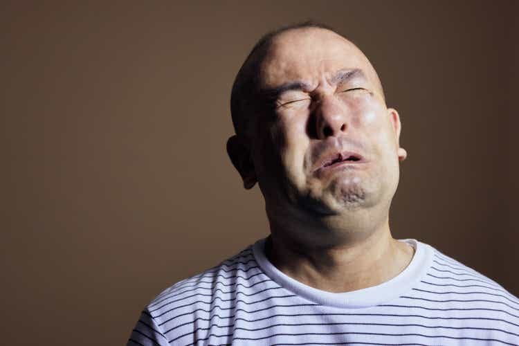 Mature man in studio against brown background with high