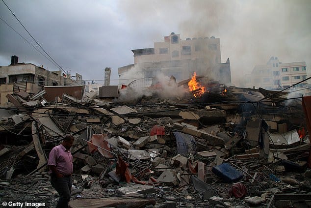 Palestinian citizens inspect damage to their homes caused by Israeli airstrikes on October 10