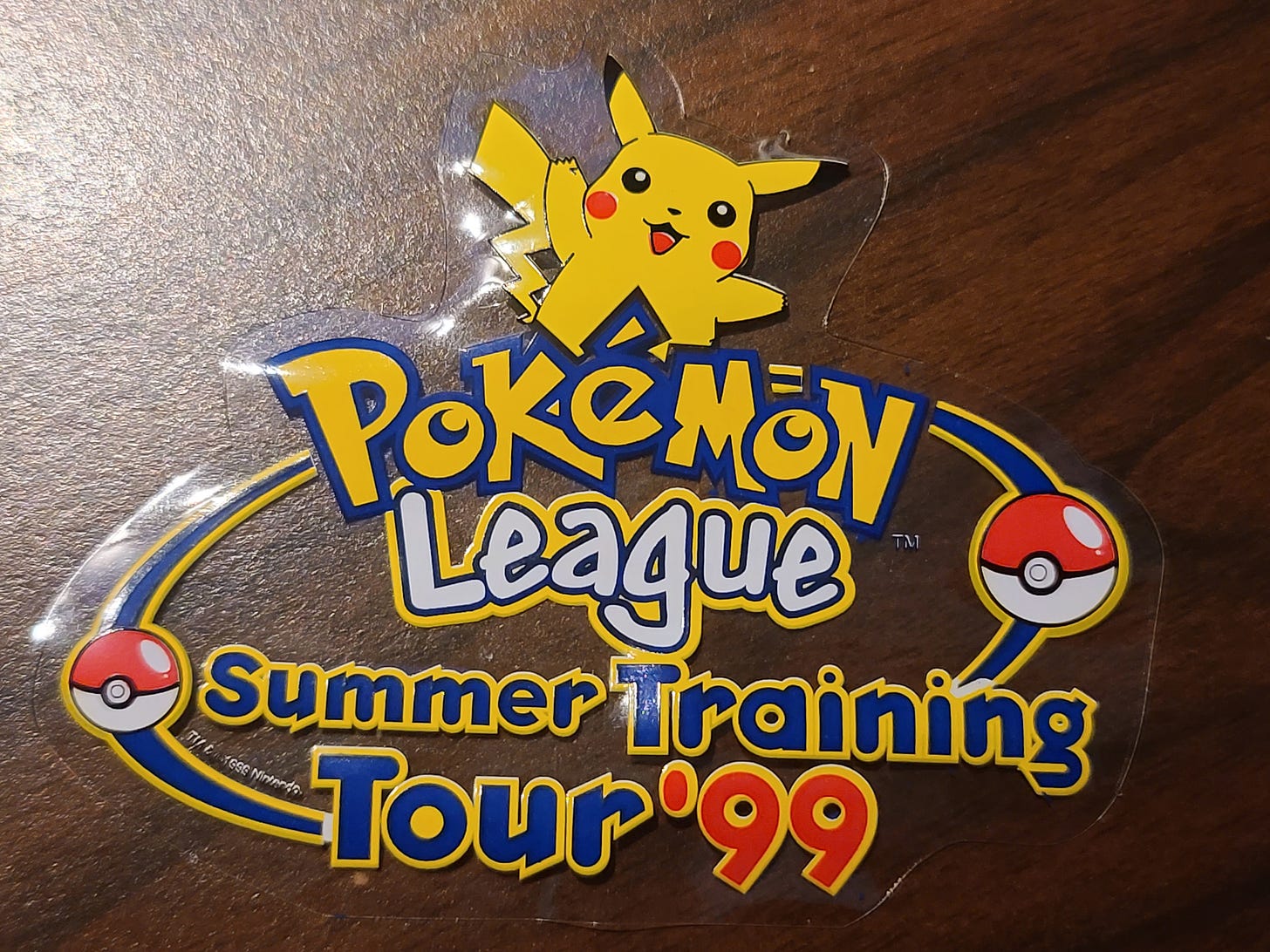 A Photograph of Jim's window sticker, with the logo from the Pokémon League Summer Training Tour 1999