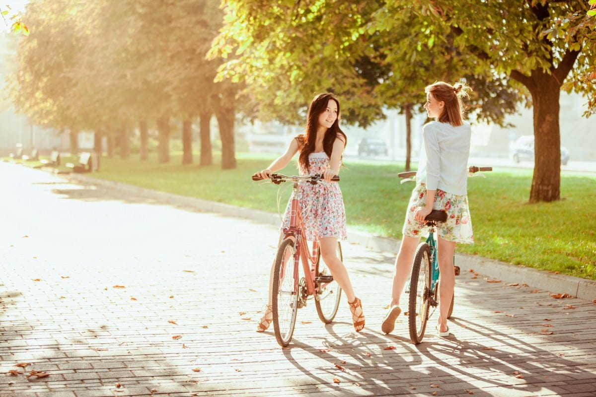 bike, girl, young, bicycle, park, people, happy, two, lifestyle, woman, sport, cyclist, cycle, summer, active, beautiful, ride, fun, outdoors, activity, outside, smile, cheerful, person, biking, leisure, female, fashion, cute, joy, teen, youth, together, fall, town, girlfriend, friendship, pair, spring, laughing, green, girls, bicycles, sunny, grass, People in nature, photograph, yellow, light, sunlight, tree, beauty, orange, leaf, autumn, holding hands, dress, street fashion, morning, photography, gesture, vehicle, romance, plant, recreation, love, backlighting, bank, walking, engagement, photo shoot