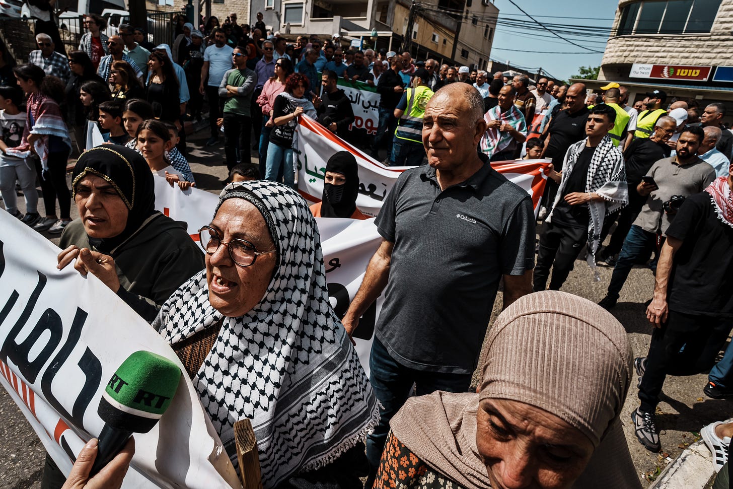Palestinian citizens of Israel march with anti-war banners and Palestinian flags during a rally calling for a ceasefire in Gaza and marking the 48th anniversary of Land Day in the town of Deir Hanna, Israel, on March 30, 2024.
