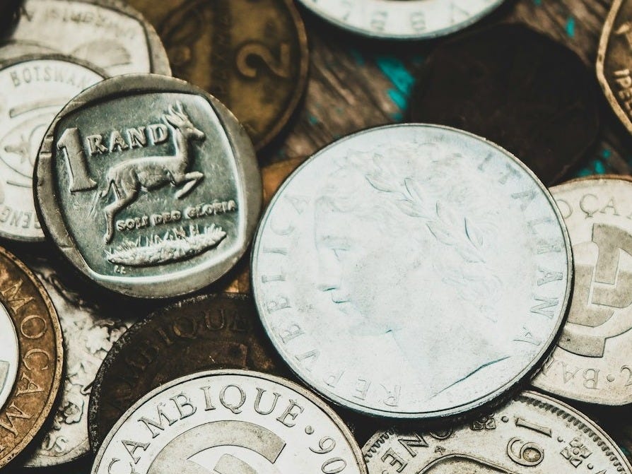 a pile of different types of coins