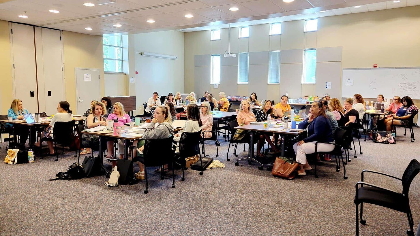 This image shows a group of educators in a room for ESS Leadership Camp.