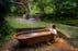 A woman baths in a tub filled with hot spring water in Dominica.