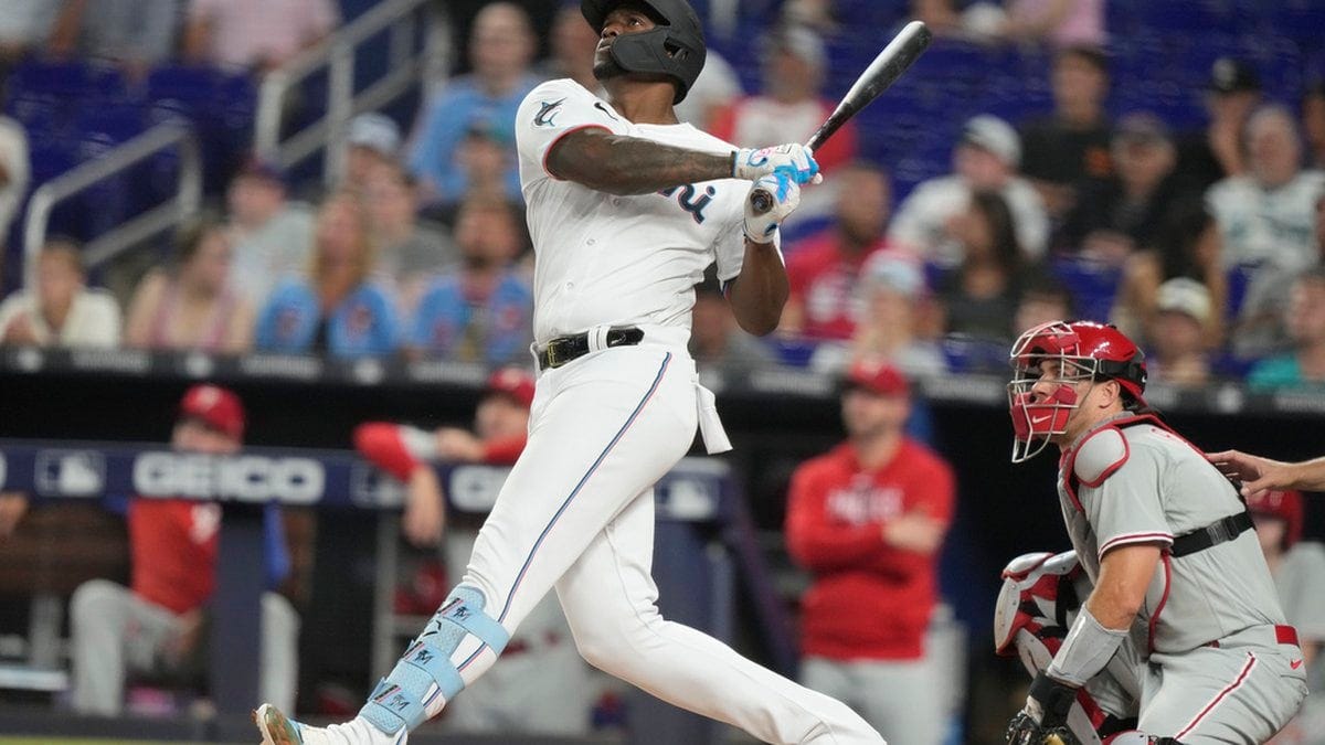 Miami Marlins' Jorge Soler, left, hits a two-run home run during the first inning of a baseball...