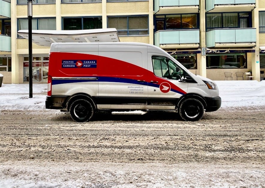 blue and white van parked near white concrete building during daytime