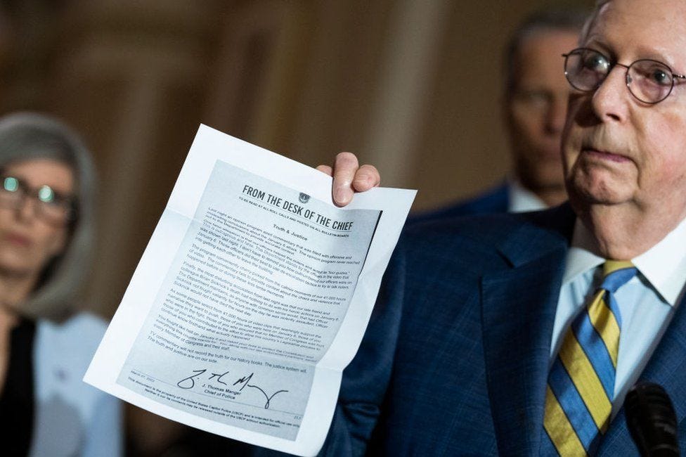 Republican Senator Mitch McConnell shows reporters a copy of the memo