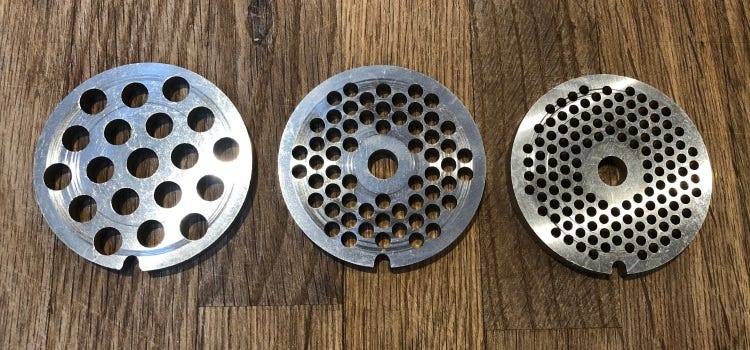 three differing sizes of mincer plates, small hole, medium hole and large hole