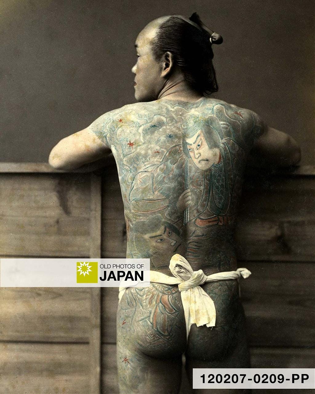 Albumen print by Japanese photographer Kimbei Kusakabe of a Japanese man with full-body tattoos wearing only a fundoshi (褌) loin cloth, 1890s