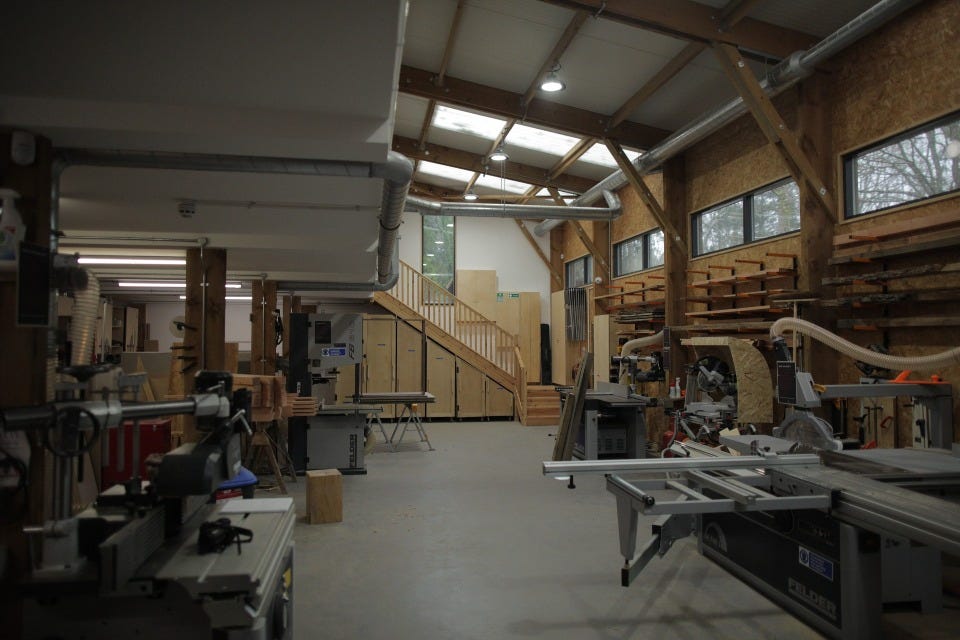 Image of an empty workshop - a CNC machine can be seen on the right hand side.