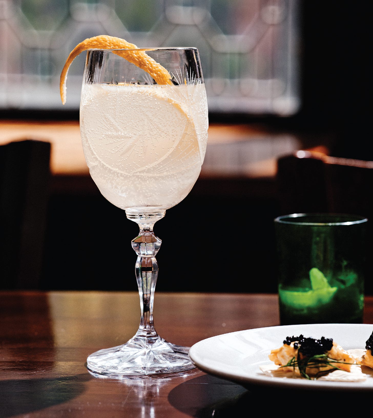 French 75 in a stemmed glass with long twist of citrus