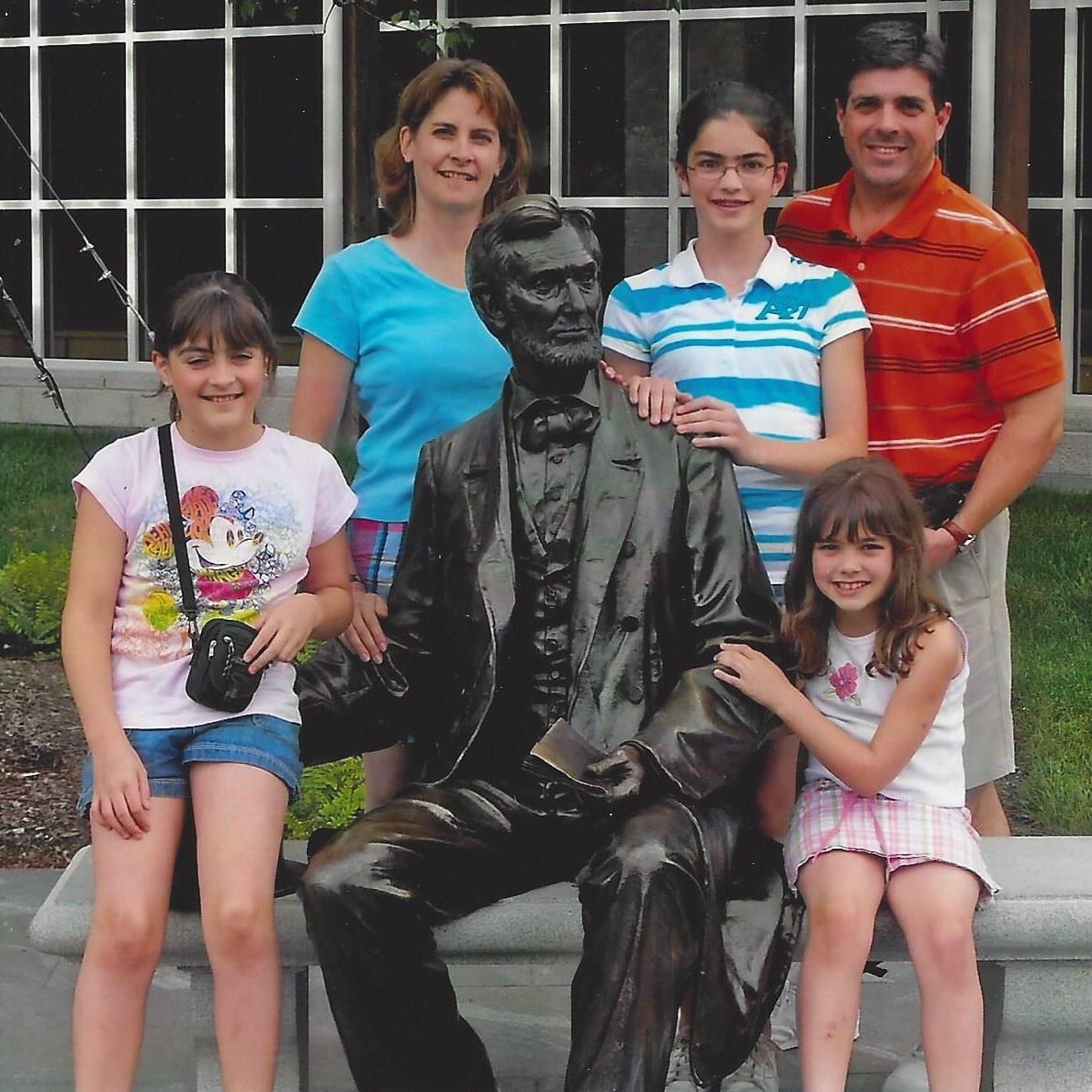 Family is posed with life-sized statue of Abraham Lincoln outside the Gettysburg Museum and Visitors Center.