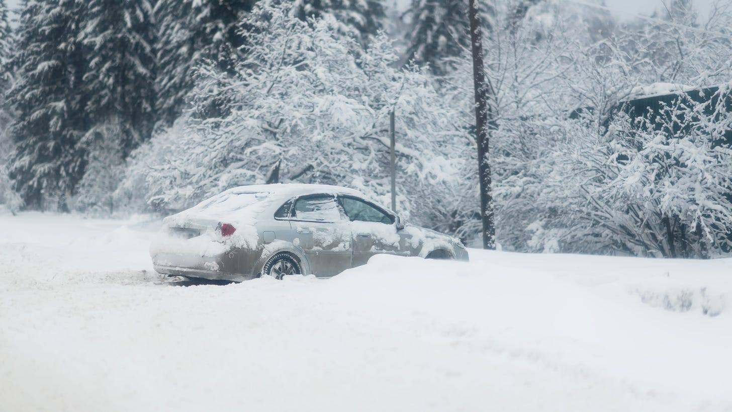 Car in snowy ditch