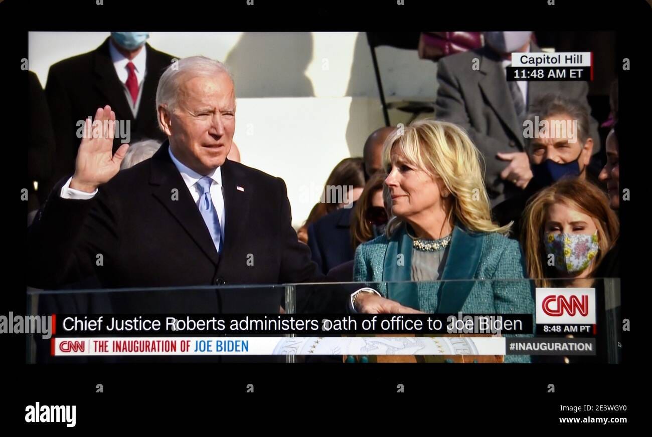A CNN television screen shot of U.S. President Joe Biden being sworn in at  his 2021 inauguration in Washington, D.C. with his wife, Dr. Jill Biden  Stock Photo - Alamy