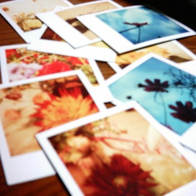 A collection of Polaroid images spread on a table