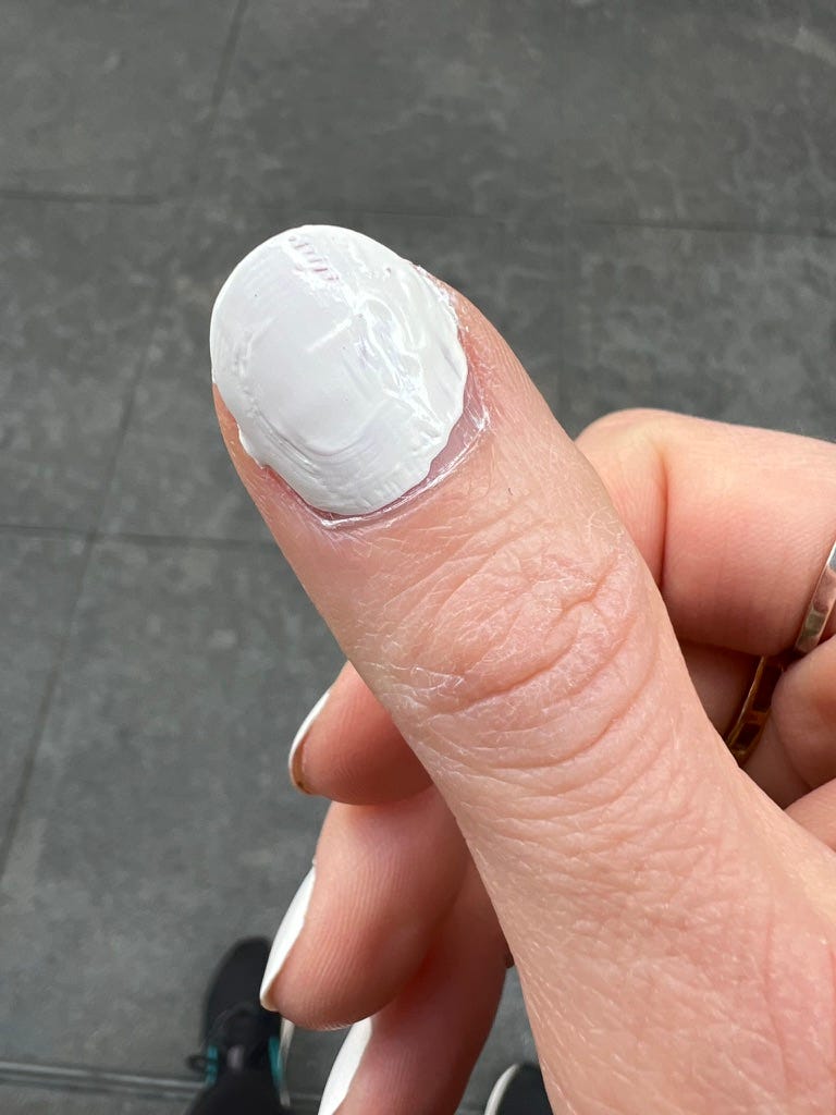 Blotchy white nail polish on my right thumbnail