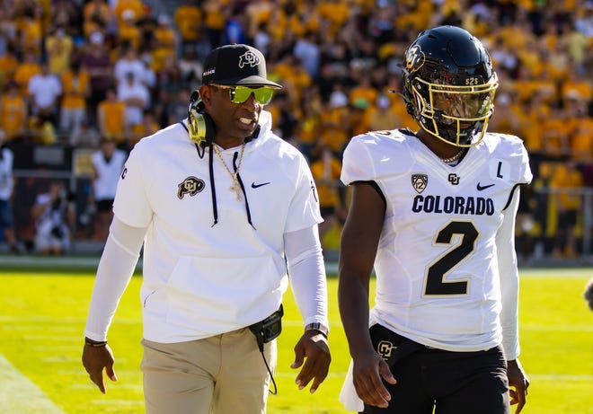 Oct 7, 2023; Tempe, Arizona, USA; Colorado Buffaloes head coach Deion Sanders with son and quarterback Shedeur Sanders (2) against the Arizona State Sun Devils at Mountain America Stadium. Mandatory Credit: Mark J. Rebilas-USA TODAY Sports
