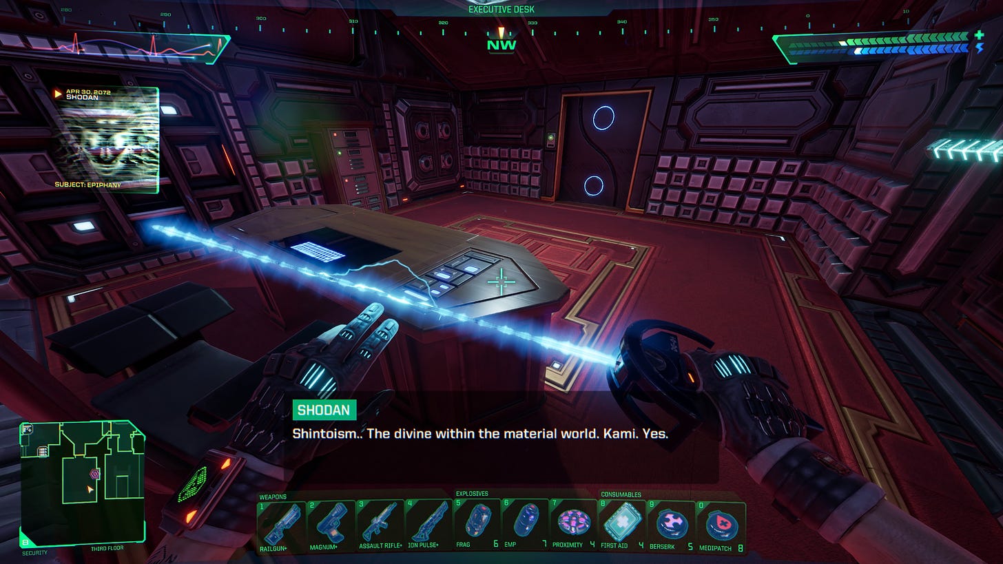 A screenshot of the game System Shock in its remake version of 2023. It shows the player in first-person perspective in an office room listening to the audio log titled Subject: Epiphany. The caption says: "SHODAN: Shintoism... The divine within the material world. Kami. Yes."