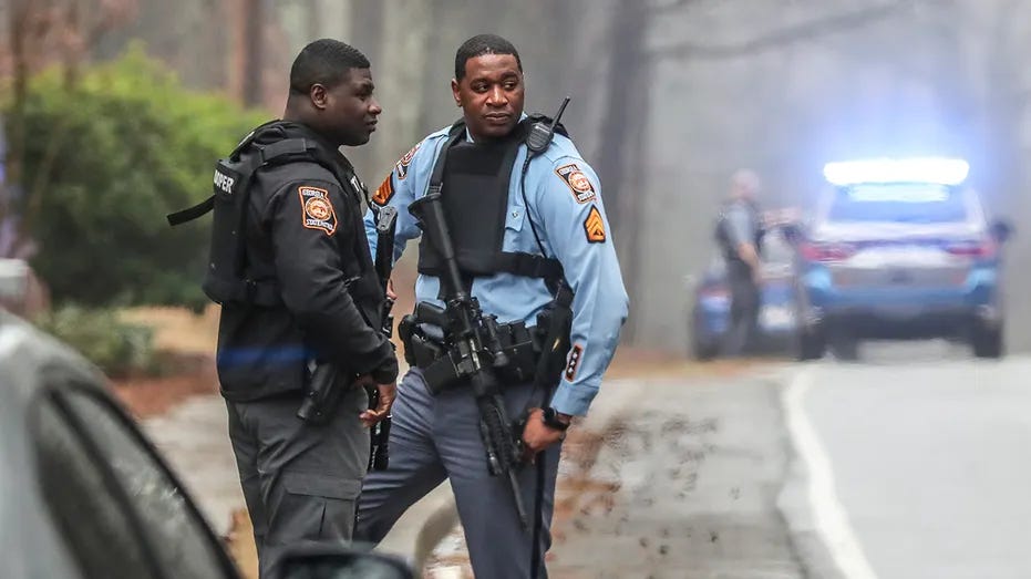 Georgia state troopers stand along Key Road in Atlanta on Wednesday, Jan. 18, 2023.