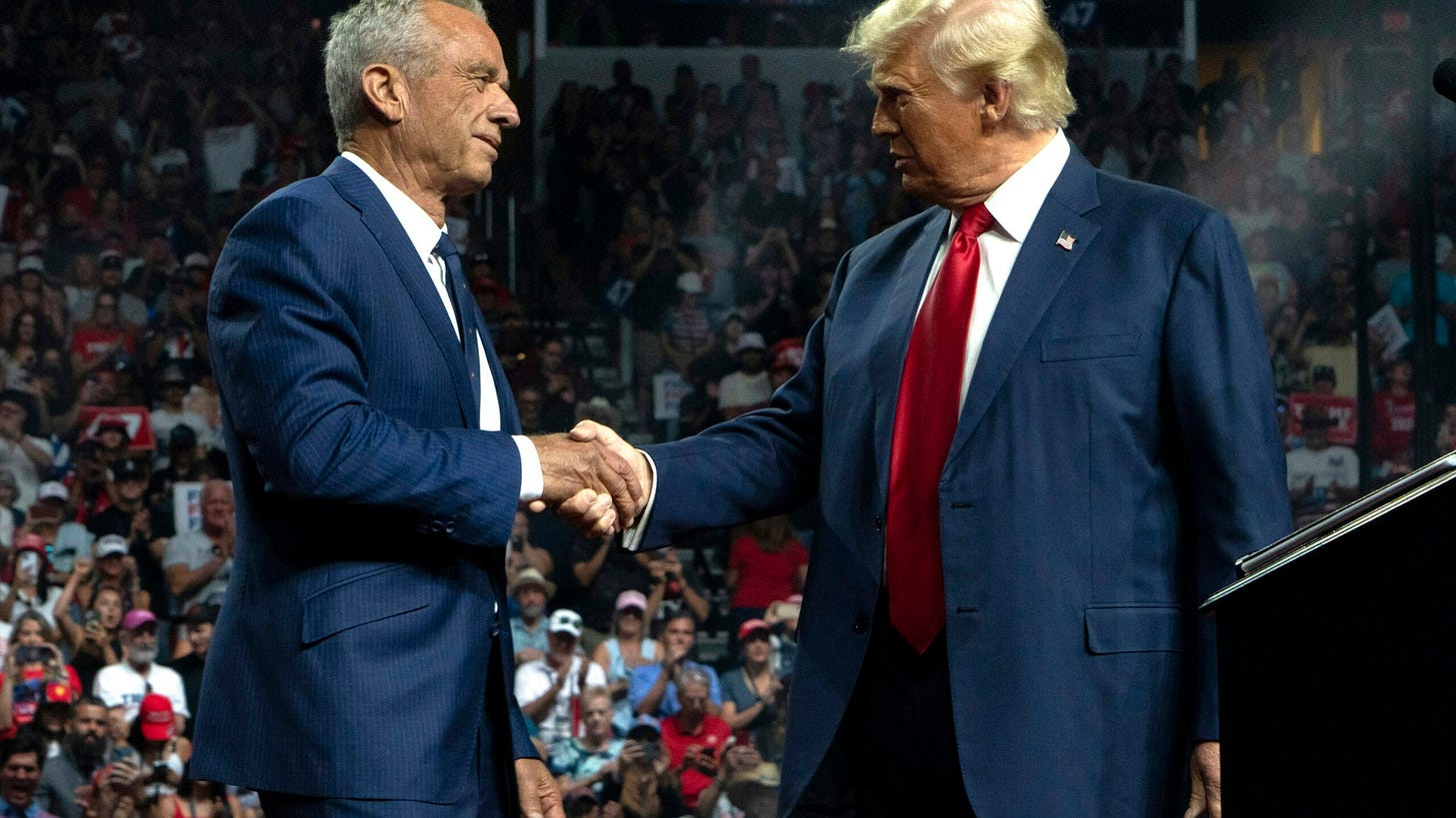 Former Republican presidential candidate Robert F. Kennedy Jr. and Republican presidential nominee, former U.S. President Donald Trump shake hands during a campaign rally at Desert Diamond Arena on August 23, 2024 in Glendale, Arizona. (Photo by Rebecca Noble/Getty Images)