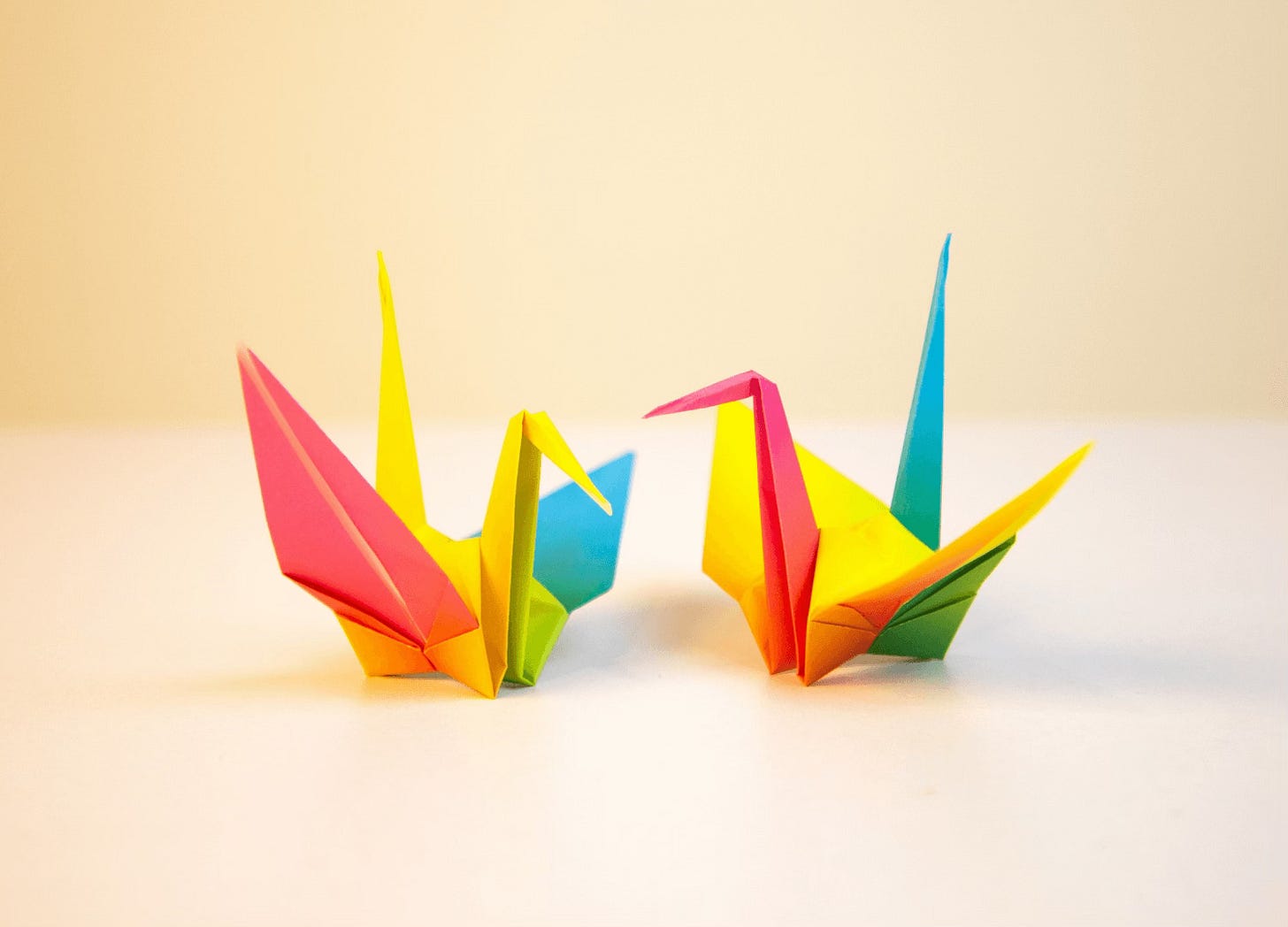 two colorful origami cranes
