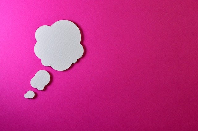 A thought bubble on a pink background