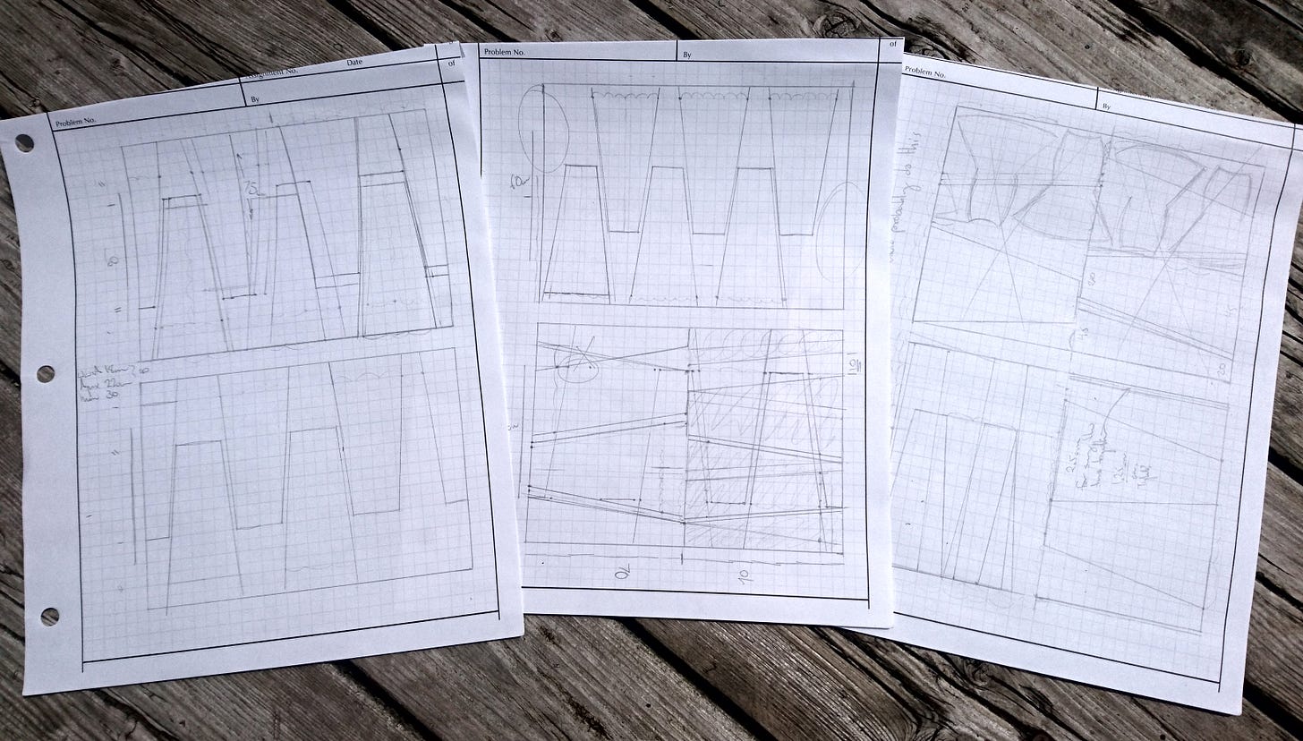 Three sheets of graph paper on a wood deck. The pages have two rectangles on them, and inside of those are various sizes of trapezoids