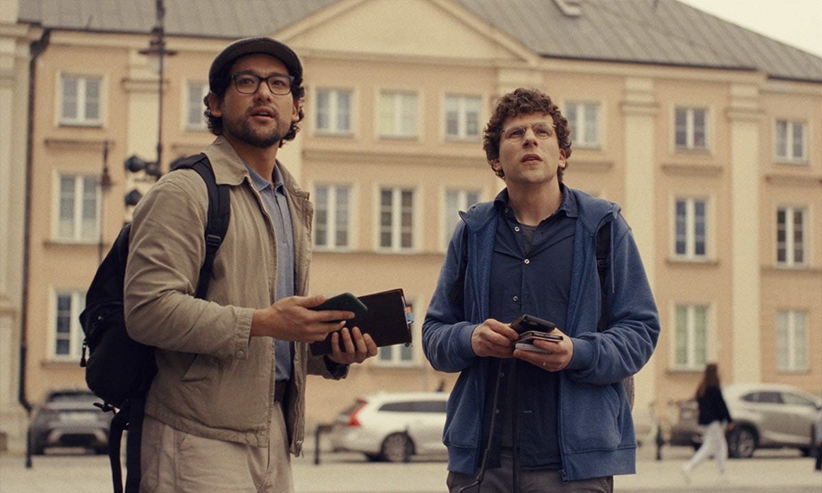 A shot from A Real Pain of Will Sharpe (left) and Jesse Eisenberg standing next to one another while on a historical tour.